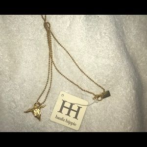 Gold cow skull necklace.